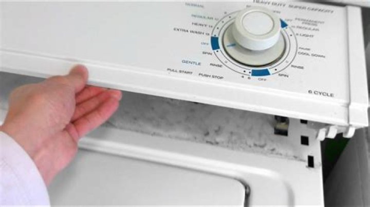 How do you remove the front panel of a Kenmore stackable washer