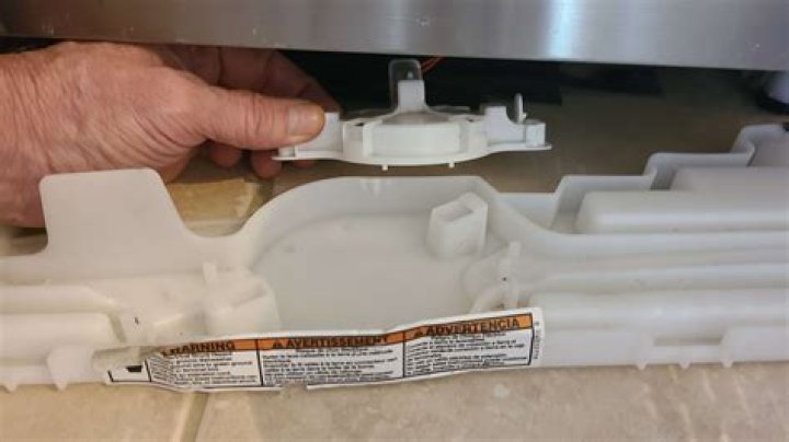 How do you take the door panel off a KitchenAid dishwasher