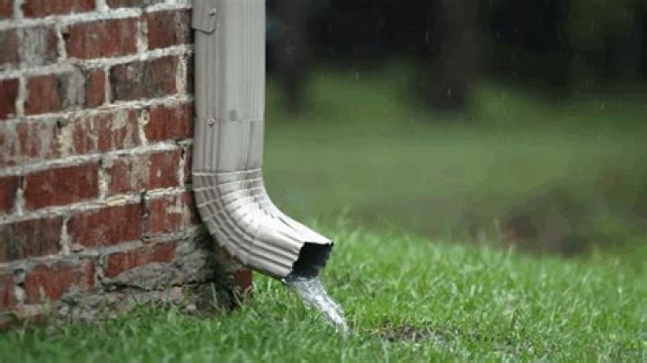 How far should gutter downspout extend from house