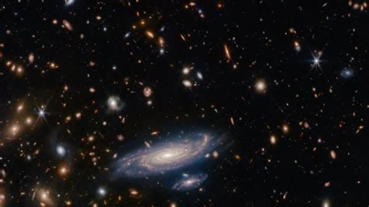 Why do galaxies further away travel faster