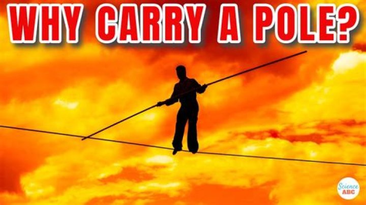 Why do tightrope walkers carry long heavy bars